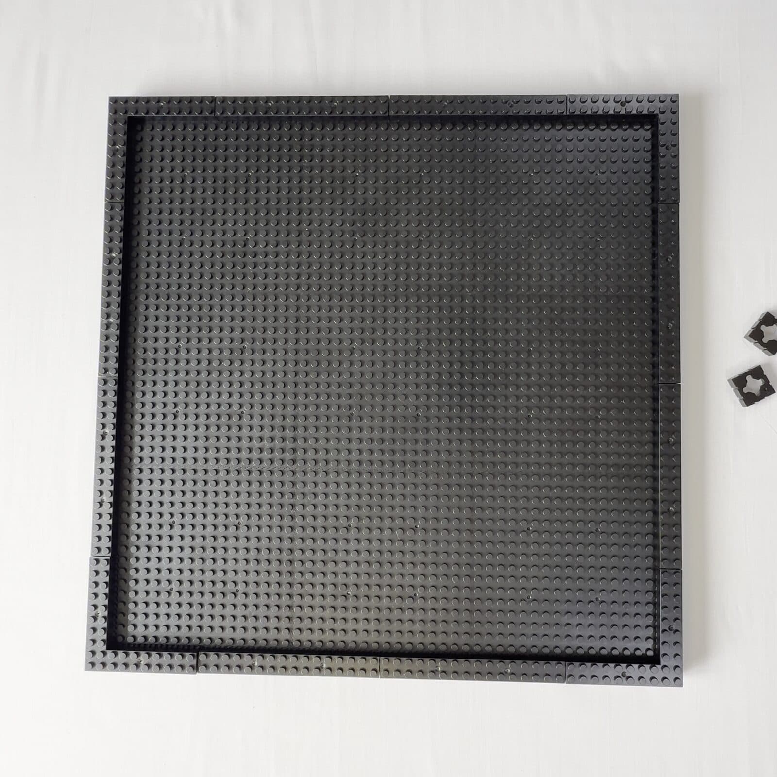 The empty baseplate board snapped together inside its brick frame